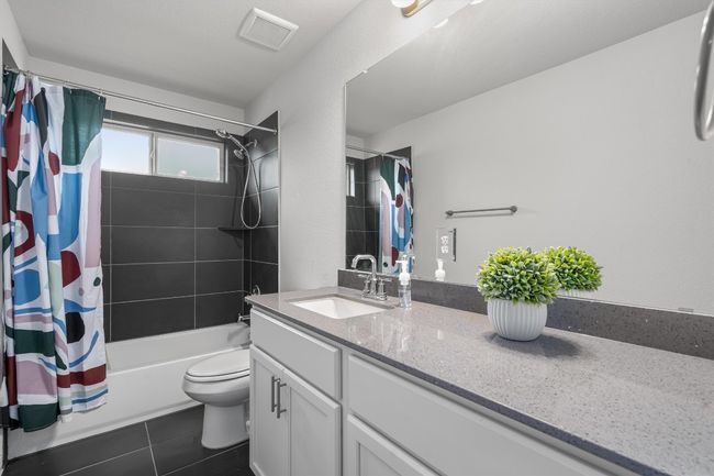 Bathroom featuring shower / bath combination with curtain, tile patterned flooring, toilet, and vanity | Image 29