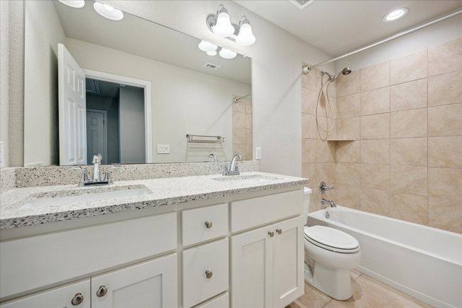 Bathroom with visible vents, a sink, toilet, and shower combination | Image 18
