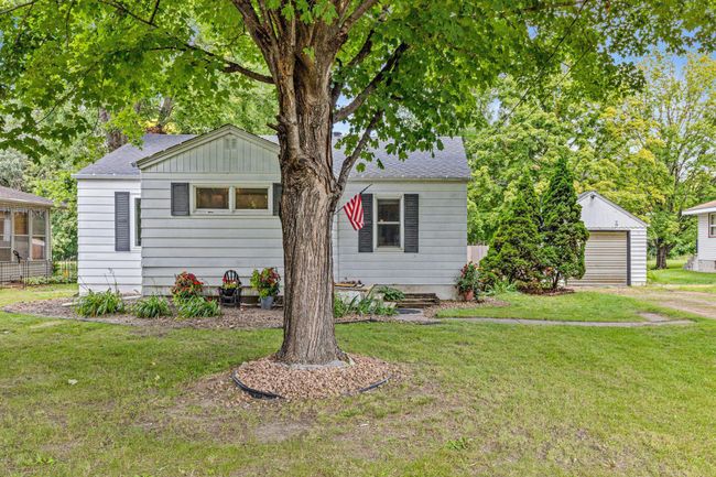 Front of home on Main Street with mature trees. | Image 30