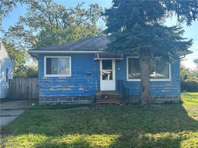 Bungalow-style house with a front lawn | Image 1