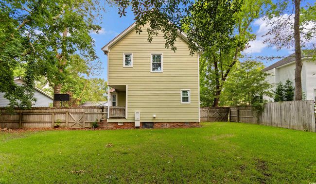 Back of property with a fenced backyard and crawl space | Image 30
