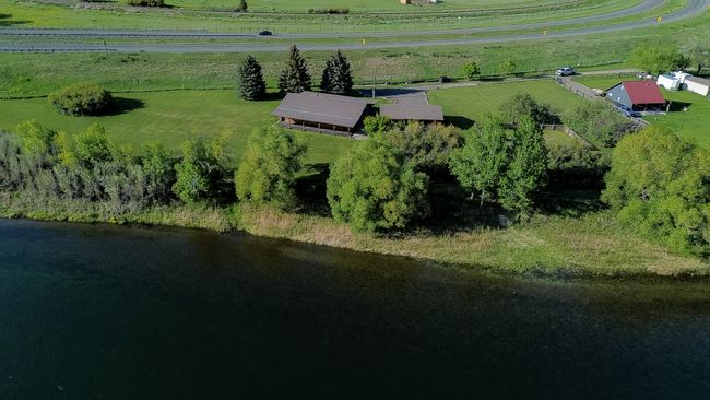 Aerial view of property and surrounding area featuring rural landscape and a large body of water | Image 7