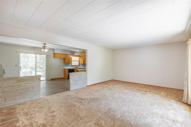 Unfurnished room with wood finished floors, baseboards, ceiling fan, and wooden walls | Image 9
