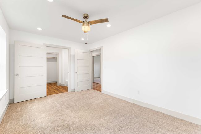 Unfurnished bedroom with carpet floors, recessed lighting, baseboards, ceiling fan, and a closet | Image 18
