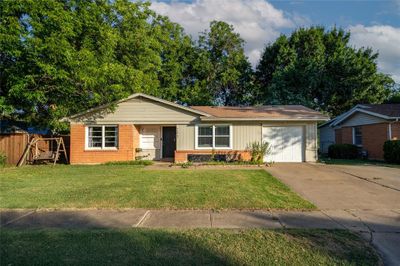 Single story home with a garage and a front yard | Image 2