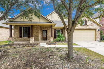 Welcome to your new home at 25209 Quiet Ledge. Beautiful brick and stone elevation creates wonderful curb appeal. | Image 1