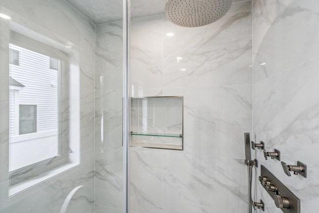 Full bathroom featuring Standup shower, vanity, and tile walls | Image 28
