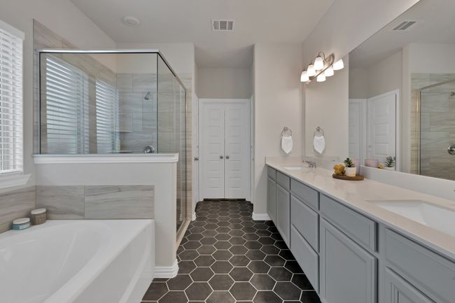 Bathroom with a sink, visible vents, a stall shower, and a bath | Image 21
