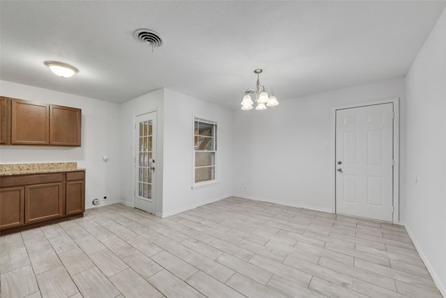 Unfurnished dining area featuring baseboards, visible vents, and an inviting chandelier | Image 8