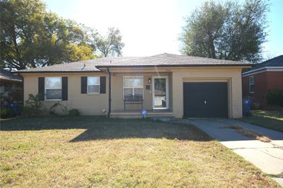 Ranch-style home featuring a front yard and a garage | Image 2