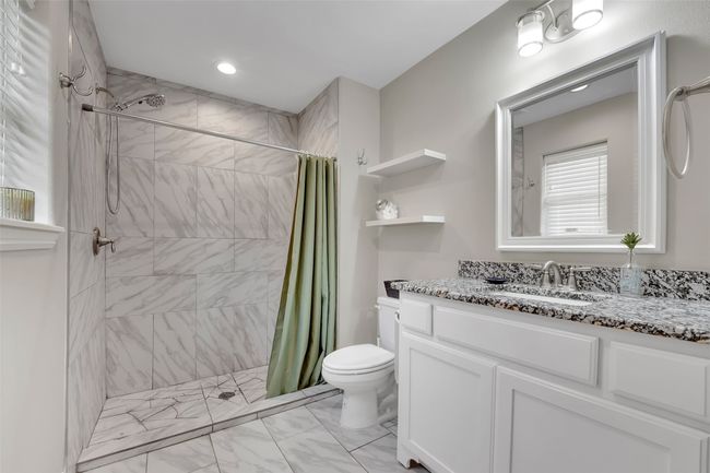Carpeted bedroom featuring ensuite bathroom, baseboards, recessed lighting, and a ceiling fan | Image 22