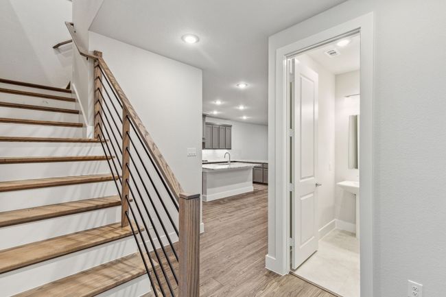 Stairs with wood finished floors and recessed lighting | Image 7