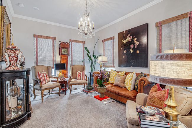 Living room with a chandelier and ornamental molding | Image 16