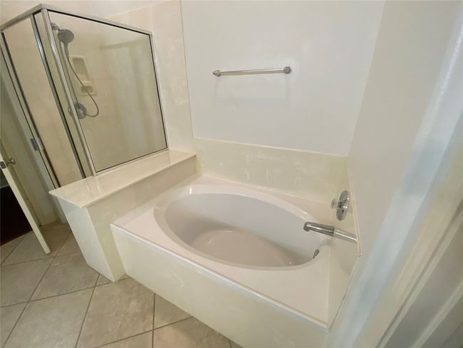 Primary bathroom featuring an oversized soaking tub with separate shower and, double vanity sinks with large walk-in closet. | Image 24