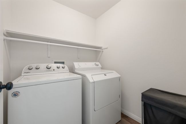 Washroom with separate washer and dryer and dark wood-style flooring | Image 33