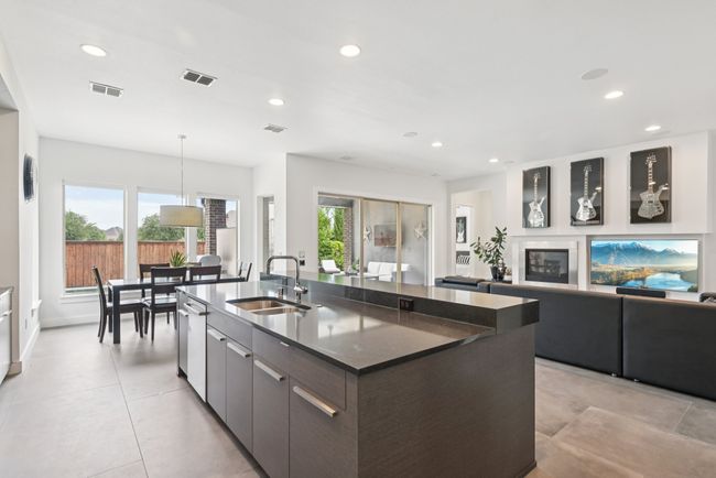 Kitchen with recessed lighting, a center island with sink, modern cabinets, dishwasher, and open floor plan | Image 8