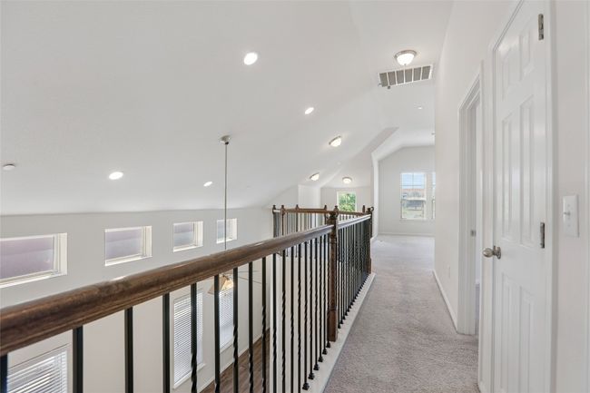 Corridor with light carpet, vaulted ceiling, visible vents, recessed lighting, and baseboards | Image 15