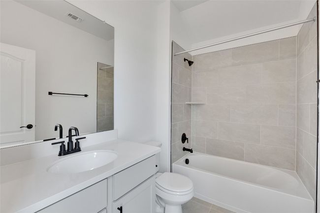 Bathroom with vanity, bathtub / shower combination, and tile patterned flooring | Image 17