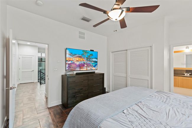 MASTER BEDROOM WITH VIEW OF BATHROOM TO RIGHT AND DOOR LEADING TO COMMON AREA ON LEFT | Image 11