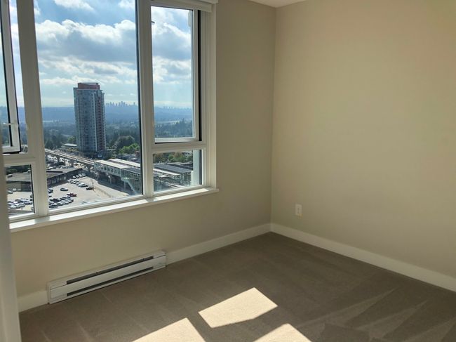 Unfurnished room with a baseboard radiator, plenty of natural light, baseboards, and carpet floors | Image 9