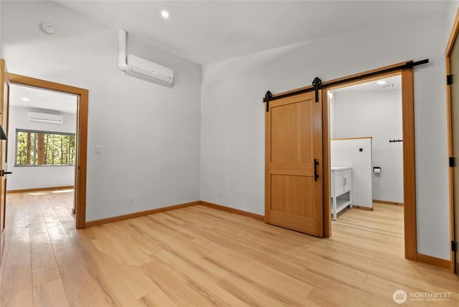 Primary bedroom on main floor with access to dining area and ensuite bathroom seen in this photo. | Image 24