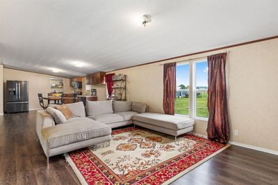 Living room featuring ornamental molding, lofted ceiling, and dark wood-type flooring | Image 3