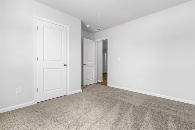 Unfurnished bedroom with carpet | Image 7