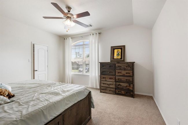 The second upstairs bedroom is a great size and features a ceiling fan and large walk-in closet. | Image 36