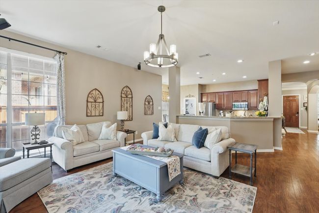 Living room featuring a chandelier, wood finished floors, recessed lighting, and baseboards | Image 7