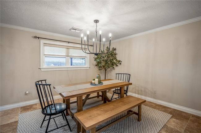Dining room with a textured ceiling, visible vents, and baseboards | Image 13