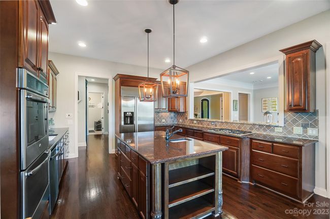 The kitchen you have been dreaming of w/ ss appliances, gas range, tons of countertop space, , center island, and breakfast bar w/ seating, makes your meal prep a delight | Image 11