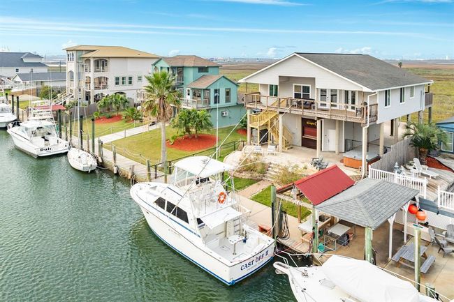 56 Marlin overlooks the canal and is surrounded by a well-maintained yard and neighboring homes. Ideal for boating enthusiasts and those seeking a serene waterside lifestyle. | Image 23