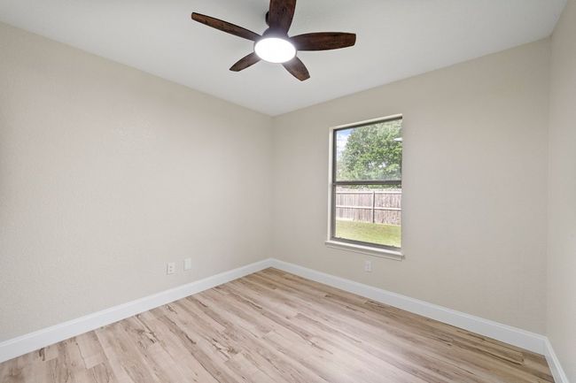 Spare room featuring a ceiling fan and light wood finished floors | Image 20