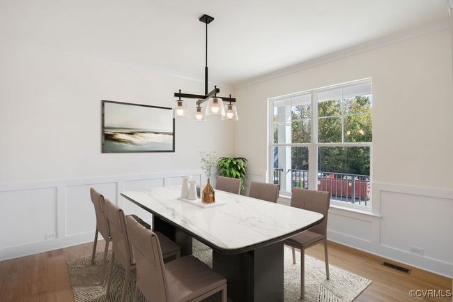VIRTUAL STAGING. Photo represents the plan with virtual staging. The first floor offers open-concept living, featuring a formal dining and living room directly off of the foyer. | Image 4