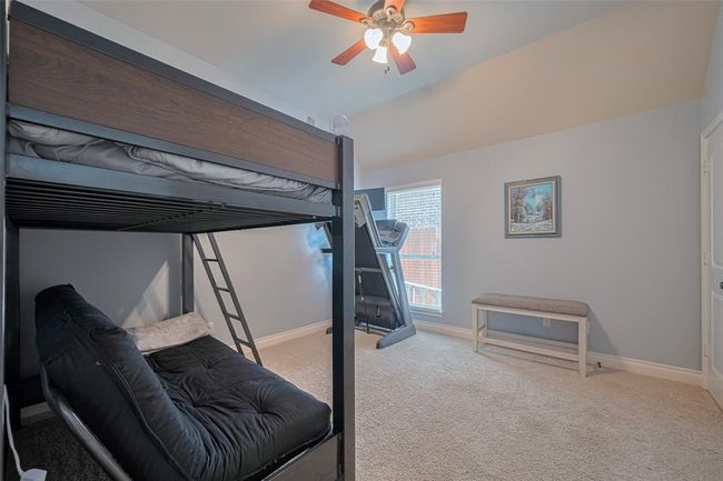 Guest Bedroom 3 features a ceiling fan and walk-in closet, situated in its own private wing of the home. | Image 27