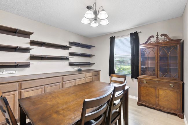 Dining space with a chandelier, a textured ceiling, and light wood-type flooring | Image 4