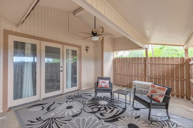 Relaxing and private back patio with ceiling fan. | Image 4