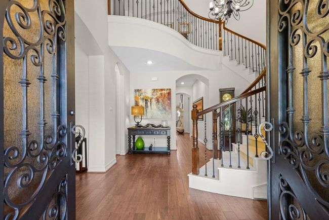 Beautiful wrought iron doors welcome you in to a formal 2-story entry with elegant hardwood floors... | Image 12