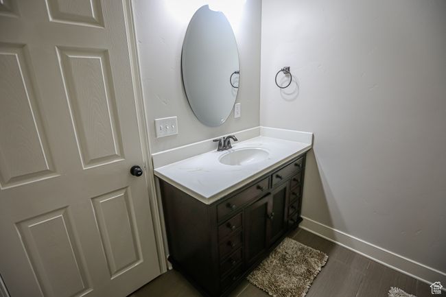 Bathroom featuring vanity, baseboards, and wood finished floors | Image 55