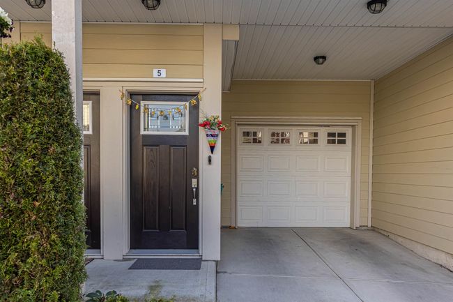 View of exterior entry featuring driveway and a garage | Image 28