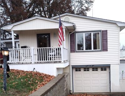 View of front facade with a garage and covered porch | Image 2