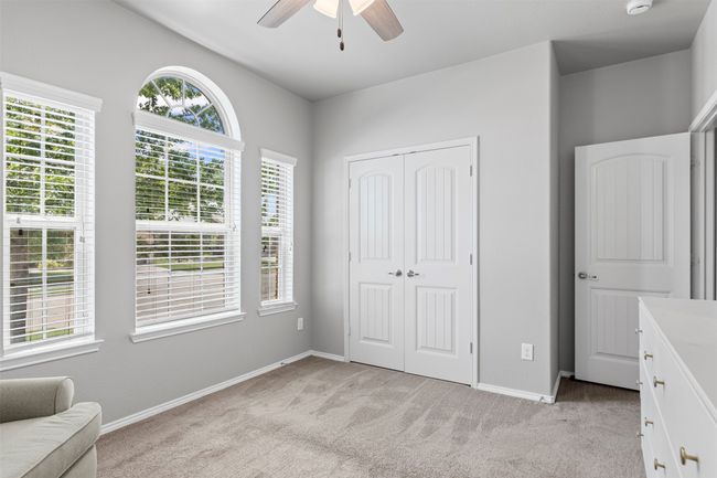 Bedroom with light carpet, a closet, and ceiling fan | Image 6