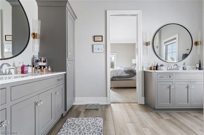 En-suite with tile flooring, plenty of natural light, and separate vanities | Image 18