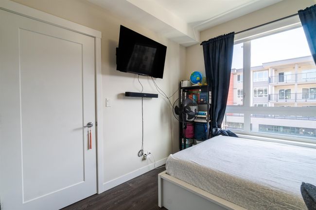 Bedroom featuring dark wood finished floors, baseboards, and multiple windows | Image 10