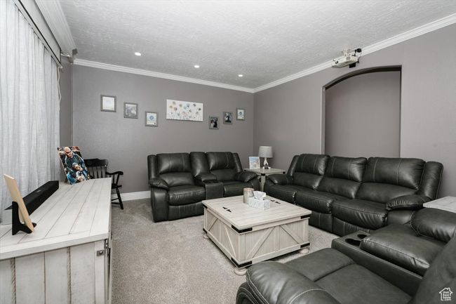 Living room with light carpet, recessed lighting, a textured ceiling, and crown molding | Image 4