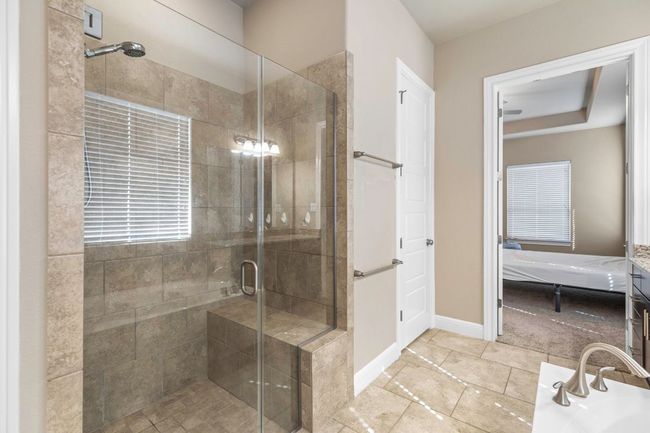Bathroom featuring a shower stall and ensuite bath | Image 20