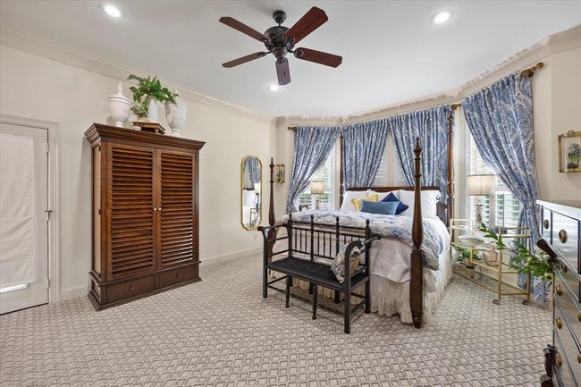 Carpeted bedroom with crown molding, ceiling fan, and multiple windows | Image 28