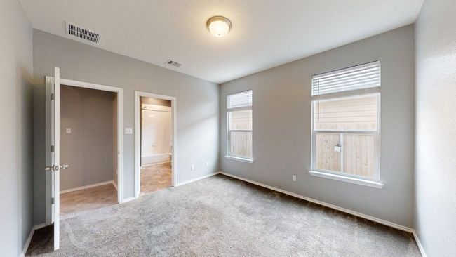 Unfurnished bedroom with carpet floors, baseboards, ensuite bathroom, and visible vents | Image 8