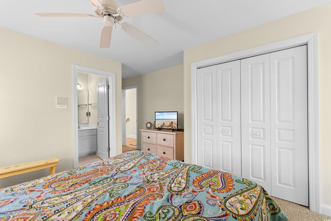 Bedroom featuring a closet, a ceiling fan, baseboards, and ensuite bath | Image 19