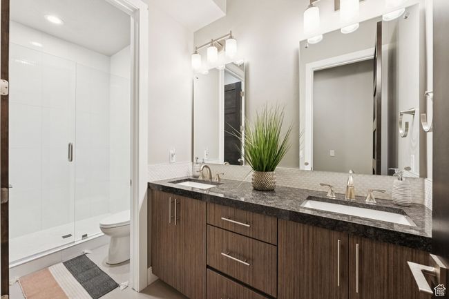 Bathroom with double vanity and a stall shower | Image 21